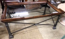 Wood and iron coffee table with a glass top
$63.30