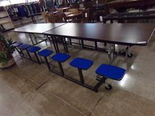 Sit 16 people.  This table collapses into a tall rolling panel for storage.  
$101.30