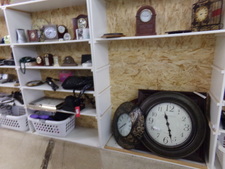 Large round clock on the bottom shelf.  We sell clocks, alarm clocks, and other small electronic items.
$26.00
