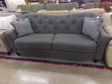 VERY GREY.  Nice couch with very thick cushions.  See the curvature frame shape.  
$225.00