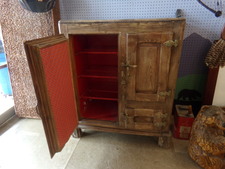 ICE BOX.  Oak cabinet vintage ice box.  Has unique cast iron water tank in center for cold water, spiquet on front center.  Oak needs re-finishing or repair in areas.  Find at front of store.  
$600.00