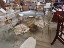 ROUND GLASS TOP TABLE has amber stone pedestal.  Chairs are heavy iron with orange accent cushions.
$75.00