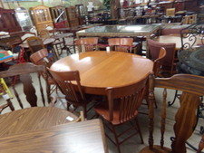 Beautiful red oak.  Solid table is oval and seats 6 chairs.  Chairs also oak are hi-backed spindle style.  sold as set.  Table can have a leaf, but sellers did not bring one.
$168.80