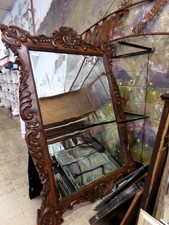 HUGE WALL MIRROR.  This ornate carved wood mirror is 5 ft x 7 ft.  
Dark wood.  Being displayed on wall at end of bedroom furniture.
$395.00