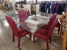 This 6 ft dining table has clear glass top, white stone-look pedestals and is surrounded by 6 red leather chairs.  (not sure of leather authenticity)  2 chairs are armed. others open
$402.30