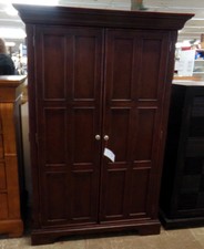 Dark wood armoire -  displayed in our bedroom furniture.
This one has organizing ability inside.
$211.00
