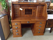 OAK ROLL TOP DESK.  This desk top has more little drawers and file options than most.  Base has computer tower and other organizing drawers.  
Enter the store, walk straight then go to the right 
$559.80