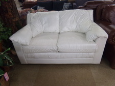 WHITE LEATHER LOVESEAT.  
$337.50